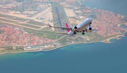 Wall Mural - Commerical passenger plane fly up over take-off runway from airport - Istanbul, Turkey