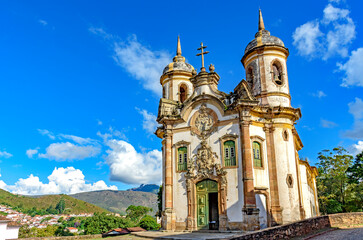 Wall Mural - Frontal view of historic baroque church lit by the sun in the famous city of Ouro Preto in Minas Gerais