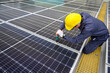 © เลิศลักษณ์ ทิพชัย - A solar power system engineer installs, maintains, and inspects solar panels on the roof of a power plant using an electric drill. offering solar cell installation inspection services.