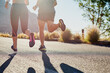© AS/peopleimages.com - Running, workout and friends or people in nature for exercise, warm up and marathon training together. Woman, man or sports coach back in mountains, trail or wellness fitness support or challenge