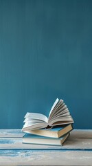 Wall Mural - Photo book stacking. open book, hardback books on wooden table and blue background. back to school. 