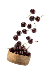 Wall Mural - Cherries falling into a plate on a white background