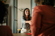 © La Famiglia - Businesswoman shaking hands with client and smiling cheerfully in meeting room. Job interview concept