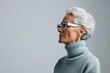 ©  Green Creator - Profile view of a mature woman with short gray hair wearing stylish glasses.