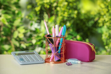 Wall Mural - Holder, pencil case, calculator and other different stationery on white table