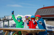 © Sergey Novikov - Smiling family of skiers takes a break and sit at snowy table