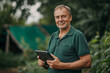© Erzsbet - Garden enginer with a tablet checkig the garden