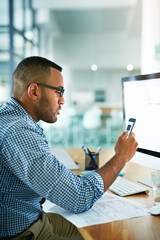 Wall Mural - Businessman, cellphone and reading at desk in office for online research, email and report for company. Male entrepreneur, internet and computer for connection, feedback and review for project