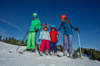 © Sergey Novikov - Family enjoying fun skiing day on a scenic snow-covered slope