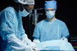 © Seventyfour - Side view portrait of African American female surgeon preparing patient for operation in operating room copy space
