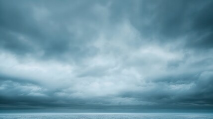 Moody ocean scene with dramatic, heavy clouds and distant horizon.