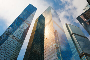 Poster - Tall office skyscrapers with sky reflection in windows, business concept banking background
