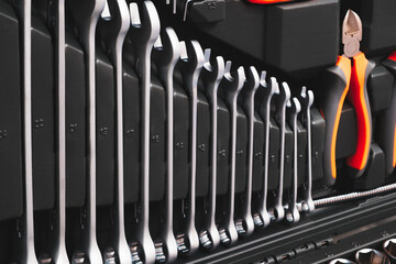 Poster - A toolbox with many different tools including pliers, wrenches, and screwdrivers. The tools are organized in a way that makes it easy to find what you need