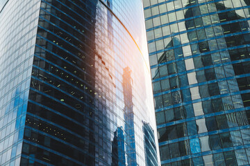 Poster - Tall office skyscrapers with sky reflection in windows, business concept banking background