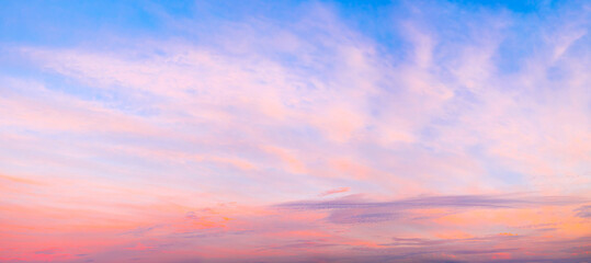 Aufkleber - A beautiful sunset with a red and blue sky. The sky is filled with clouds and the sun is setting