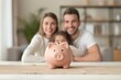 © Eugen - A family gathers around a table with a piggy bank