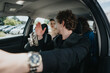 © qunica.com - A group of businesspeople in a car, engaging in conversation while driving. Ideal for concepts like teamwork, commuting, business travel, and carpooling.