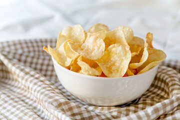 Wall Mural - Balado cassava chips in a small white bowl on a checkered tablecloth with Indonesian flavors