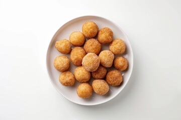 Bird s eye view of cassava balls with brown sugar on white plate