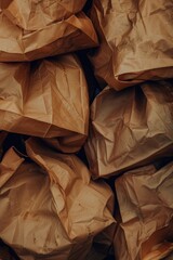 Poster - A pile of brown paper bags stacked on top of each other, ideal for use in scenes involving everyday items or office settings