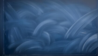 Wall Mural - a copy space image of a dark blue chalkboard with traces of erasing creating a textured background