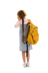 Wall Mural - Little schoolgirl in headphones with backpack on white background, back view