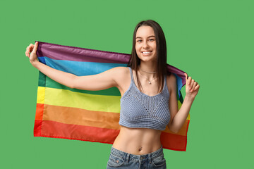 Poster - Beautiful young happy woman with piercing navel and LGBT flag on green background