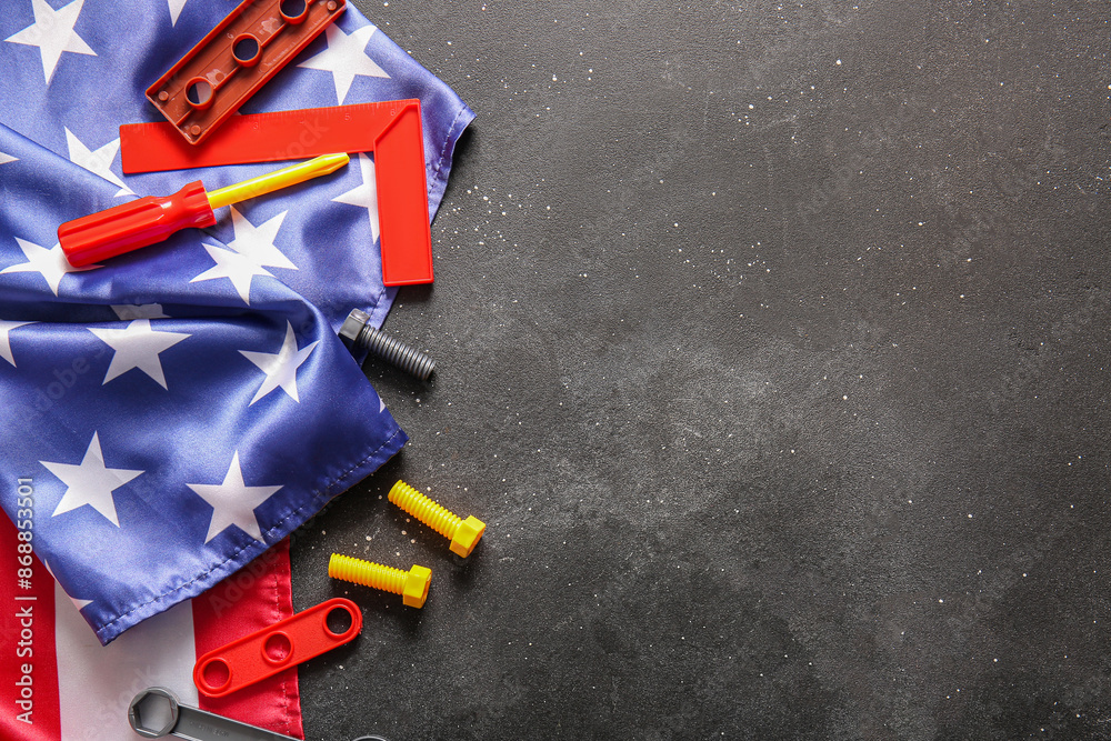 Set of toy tools and USA flag on grey grunge background. Labor Day celebration
