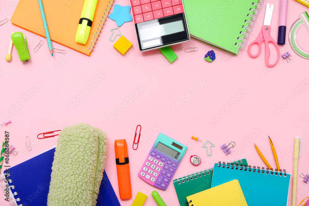 School supplies with notebooks,  calculator and markers on pink background. Top view