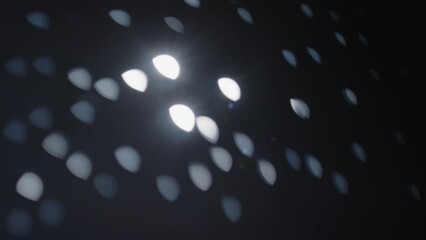 Wall Mural - A blurry image of a dark sky with a bright moon. The moon is surrounded by many small dots, creating a sense of movement and energy. The image evokes a feeling of wonder