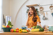 © Art_Photo - Portrait happy beauty slim healthy asian woman use phone and vegan food healthy fresh vegetable and fruit in kitchen.diet, vegetarian, eating, fruit, wellness, health, green food.Fitness, healthy food