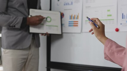 Wall Mural - Businessman is reading and analyzing a business report while in a meeting summarizing the company's financial results.