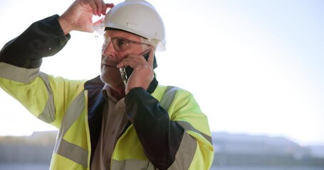 Canvas Print - Talking, contractor and phone call on building site for communication and construction project planning. Mobile tech, conversation and man with helmet for progress update, schedule or inspection