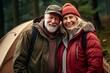 © Baba Images - Portrait of a smiling couple in front of tent outdoors