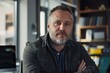 © CojanAI - Portrait of a middle aged male worker in startup company office