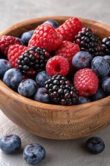 Wall Mural - Assortment of fresh berries in a wooden bowl