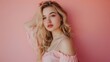 © Farid - Beautiful young blonde woman posing isolated over pink wall background.