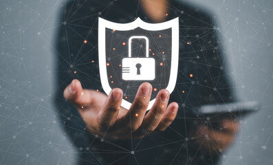 Fototapete - man holding virtual icon shield with a lock symbol, concept about security, cybersecurity and protection against dangers