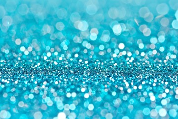 Sparkling turquoise glitter background with bokeh effect