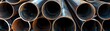 © Chanoknan - Close-up view of several stacked steel pipes, showcasing industrial materials and construction supply elements in a metallic setting.