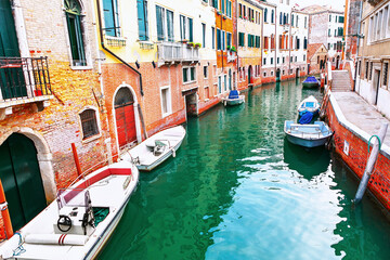 Sticker - Boats moored in the water canal of Venice. Venetian urban scene is peaceful and serene