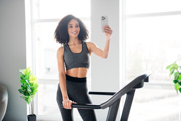 Poster - Photo of lovely adorable active girl blogger recording video physical exercises in gym daylight indoors