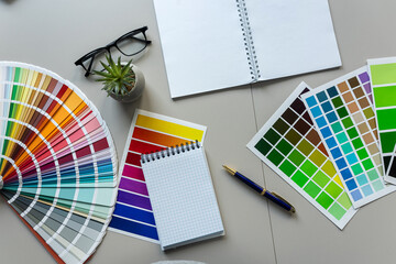 Poster - creative workplace color palette with notepad, brush. Modern graphic designer workspace