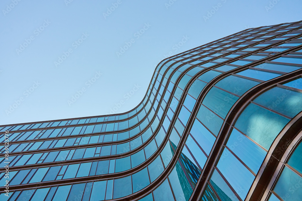modern-building-with-curved-glass-facade-reflecting-sky-contemporary