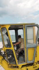 Poster - Bulldozer construction site. Shot. Top view of bulldozer driving on beach by sea. Sand mining or construction site on seashore