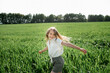 © Westend61 - Happy girl enjoying leisure time in field