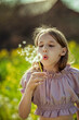 © Westend61 - Girl blowing on dandelion flower at field on sunny day