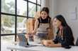© Phimwilai - Small Business Startup, SME Owner, Two Asian Female Entrepreneurs check product inventory, stock, packing, order management. SME online business ideas, delivery ideas.