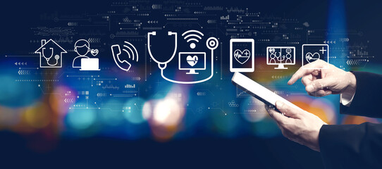 Poster - Telemedicine theme with businessman using a tablet computer at night