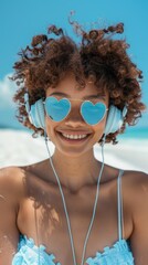 Wall Mural - A young woman wearing glasses and headphones by the seaside